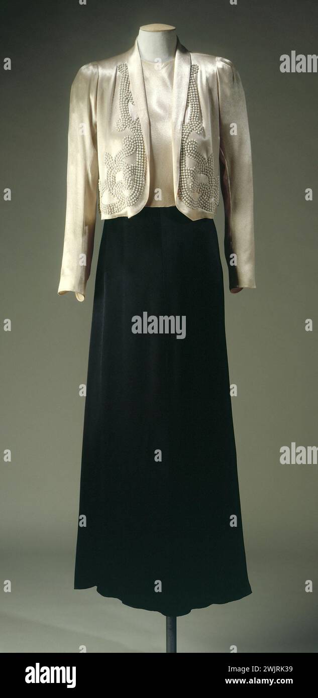 Jeanne Lanvin (1867-1946). Together evening dress in black satin and pink peach and peach pink in peach pink satin, embroidered with pink pearls on silver sequins, summer 1937 (front view). Galliera, fashion museum of the city of Paris. 25960-1 Silver, Bolero, Embroidery, Crepe, Ensemble, Female, Woman, Paillette, Pearl, Rose, Satin, evening Stock Photo