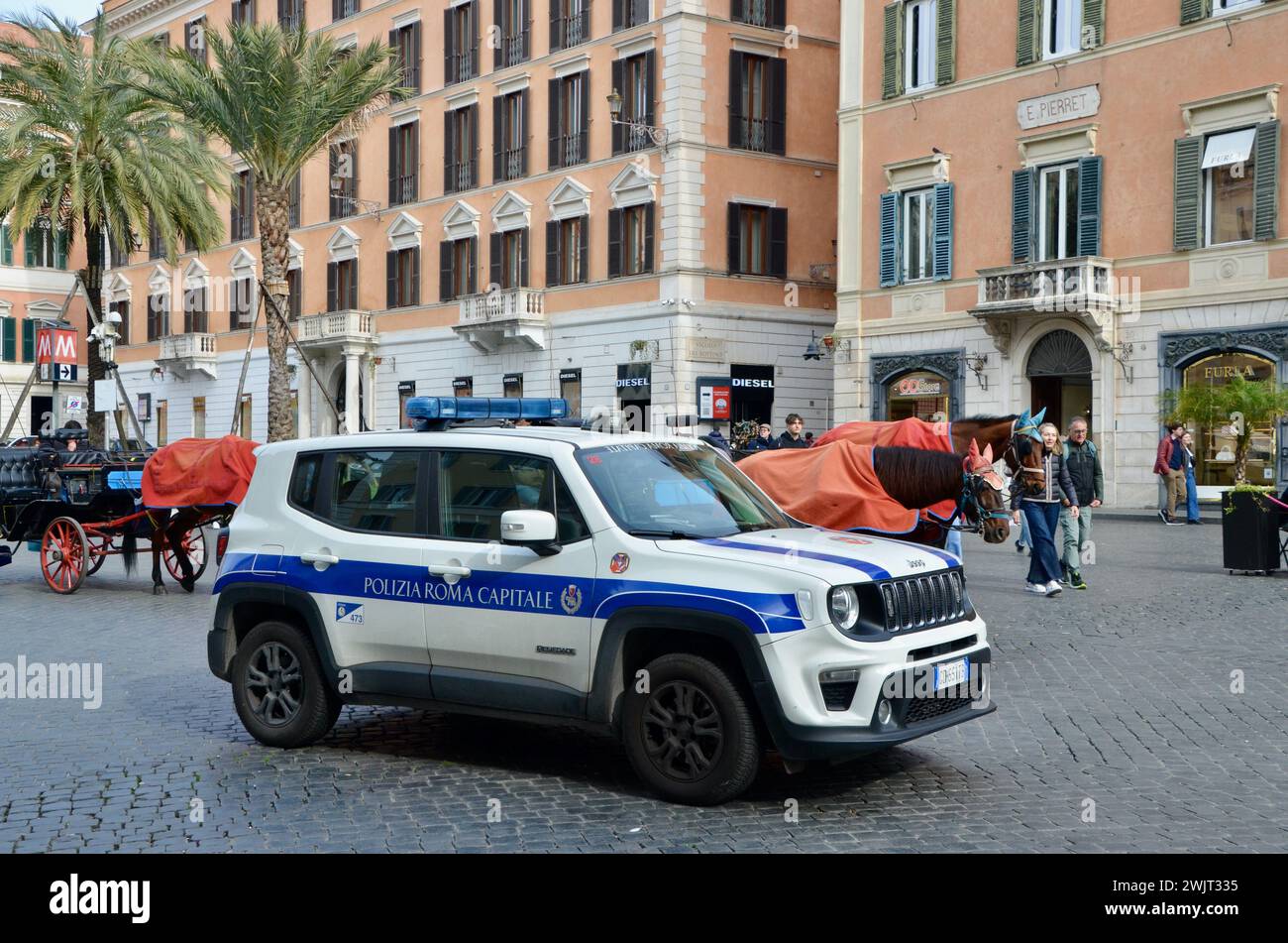 police jeep and horse drawn carriages in the spanish plaza of rome capital of italy EU Stock Photo