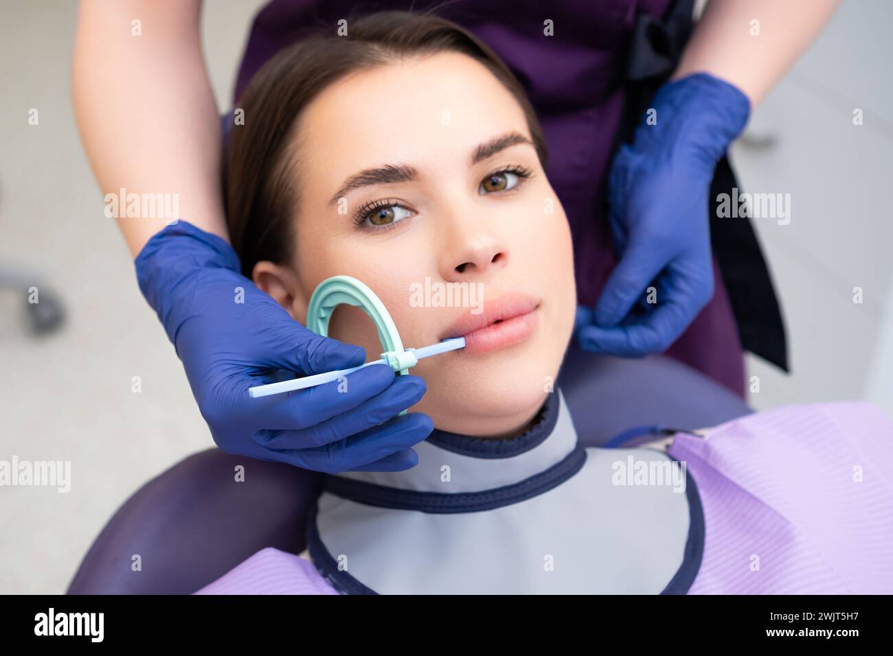Process of preparation of patient before dental Xray procedure. Woman