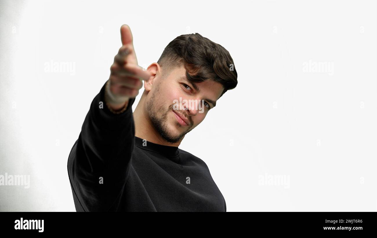 A man, close-up, on a white background, points forward Stock Photo