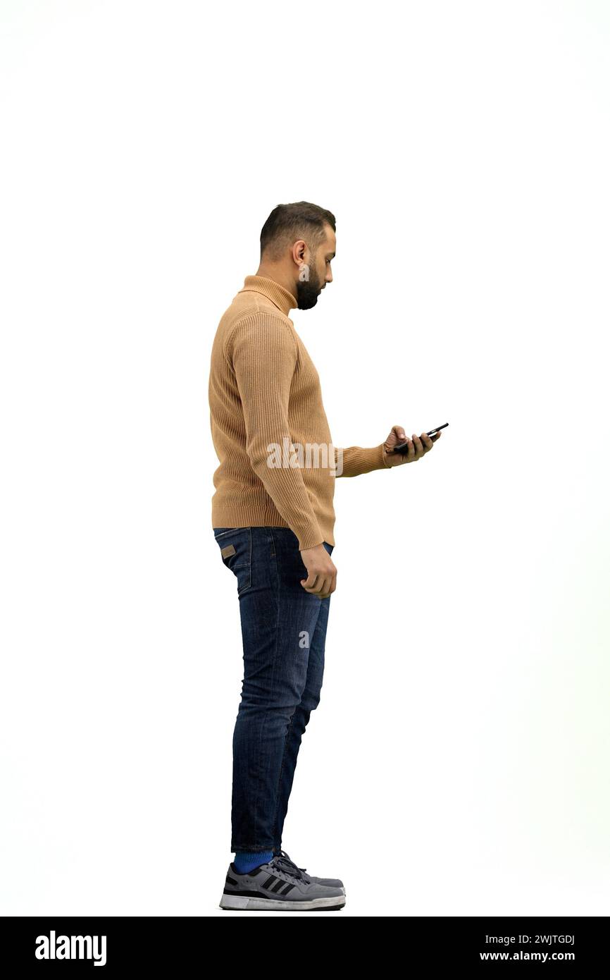 A man, full-length, on a white background, talking on the phone Stock Photo