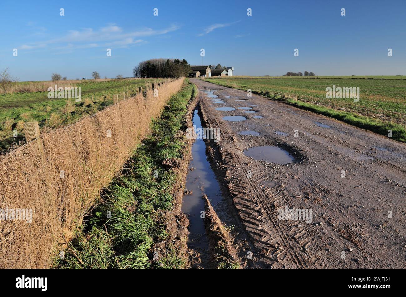 Puddles along the Imber Range Path on Westbury Hill, Wiltshire. Stock Photo