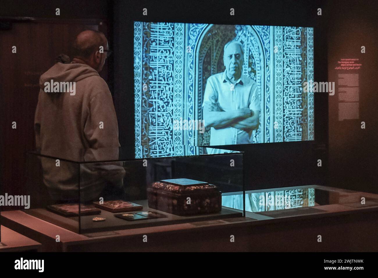 Jerusalem, Israel. 17th Feb, 2024. A museum visitor seems to be conversing with a projected character on screen. Credit: Nir Alon/Alamy Live News Stock Photo