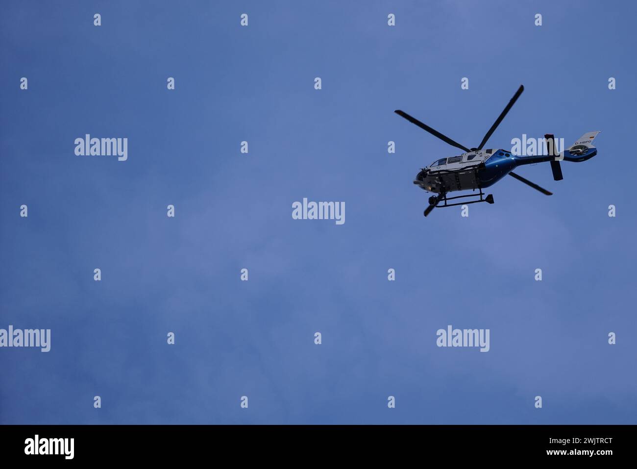 Airspace surveillance with a Police helicopter during the Munich Security Conference. Stock Photo