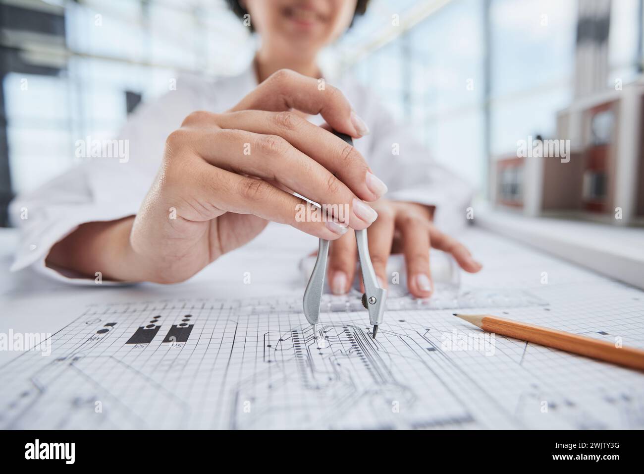 female architect designer working on blueprints Stock Photo