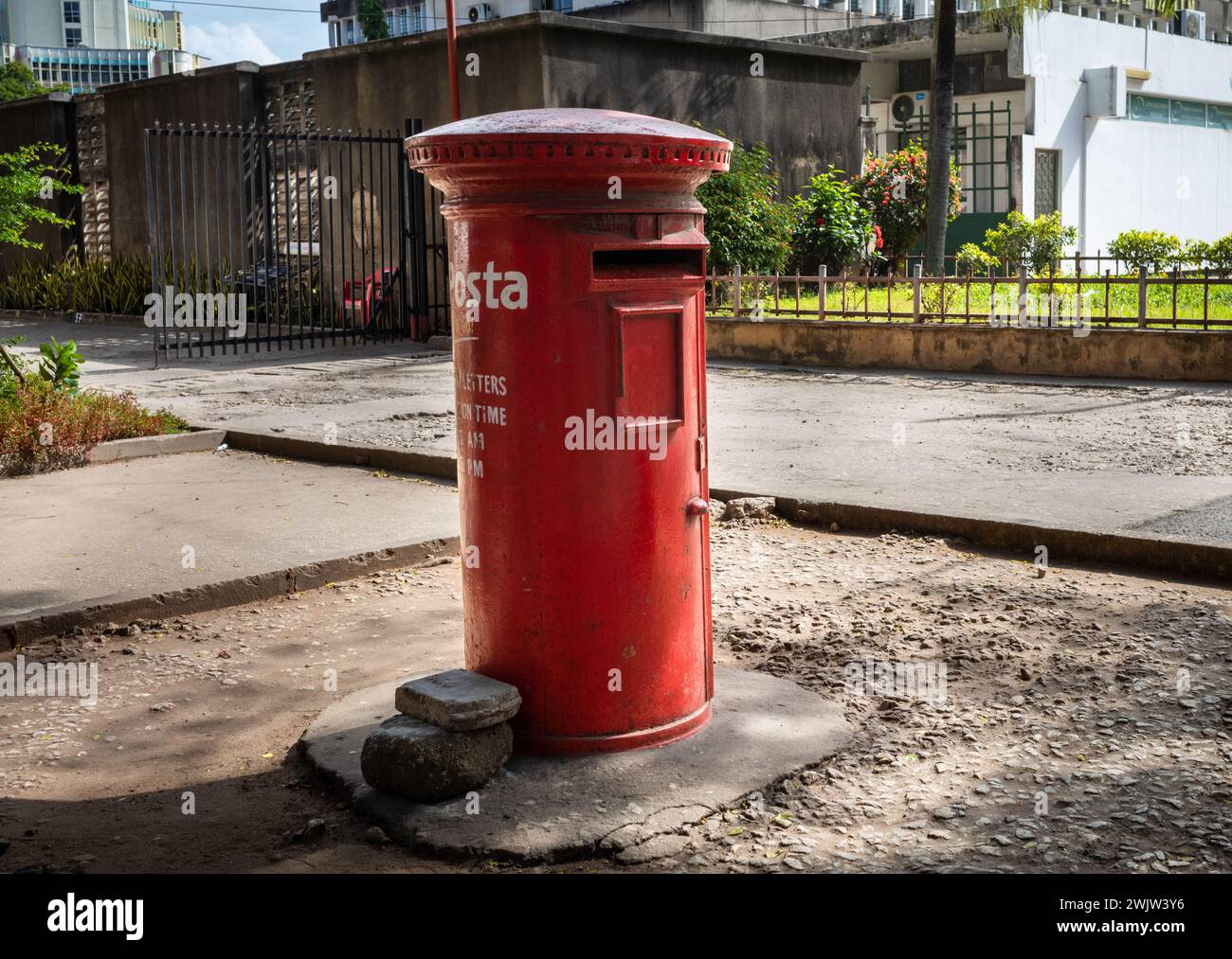 A British colonial style red pillar box, or letter box, used by Posta