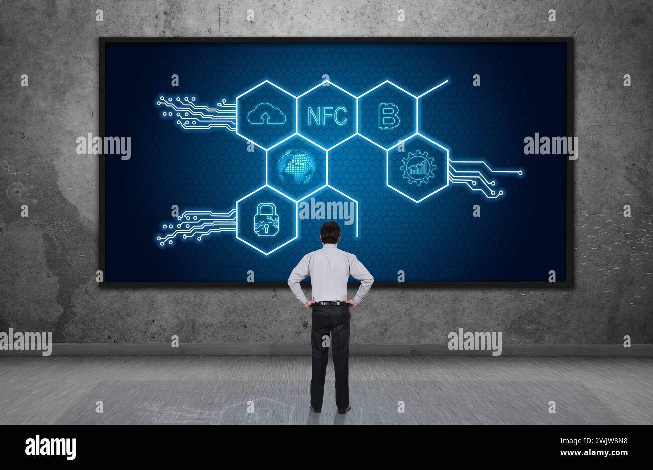 Businessman looking on digital screen with hexagons hologram. Virtual reality and global networking concept. Stock Photo