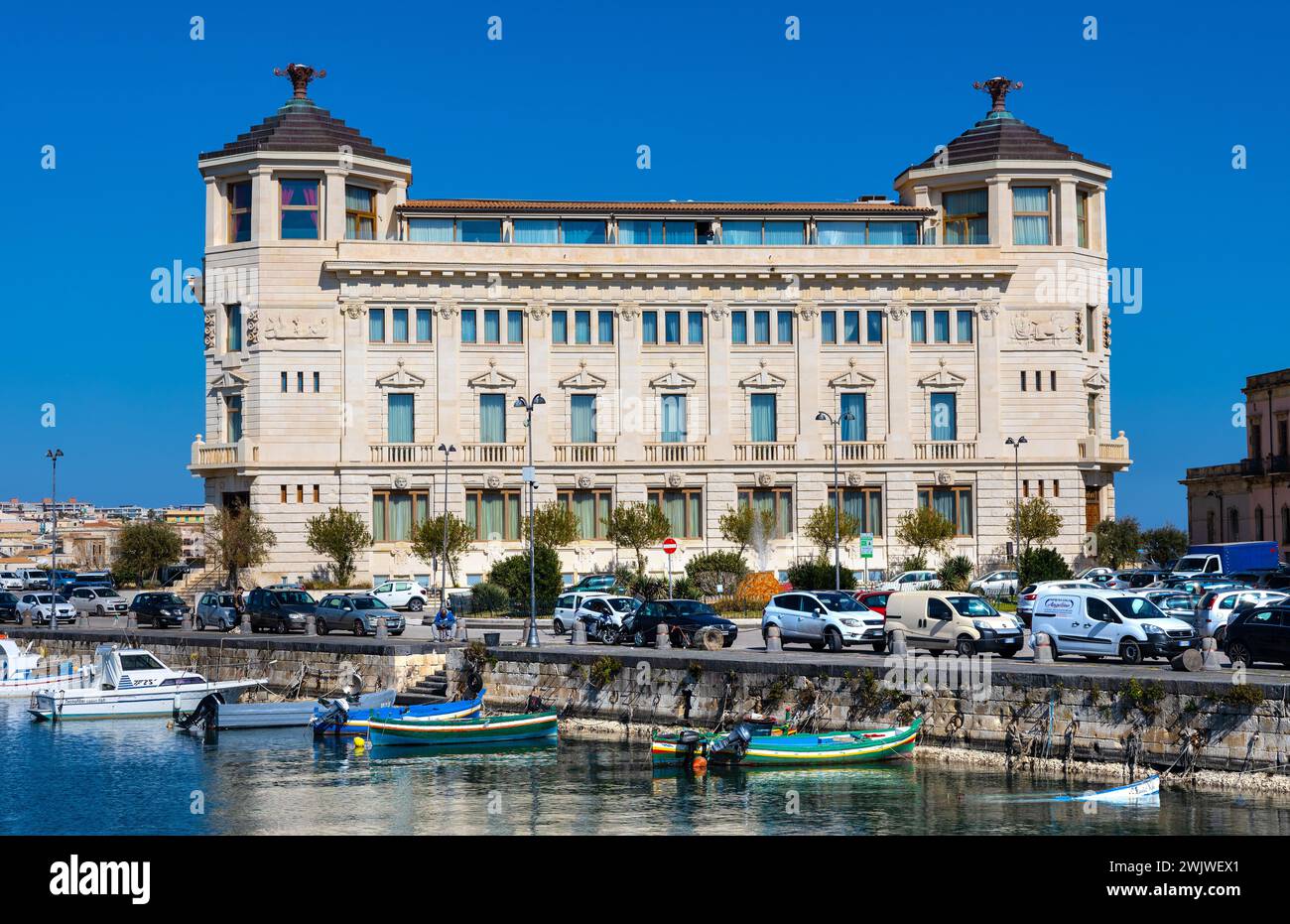 Syracuse, Sicily, Italy - February 16, 2023: Palazzo delle Poste Palace with Ortea Hotel Autograph at piazza delle Posta square and Syracuse port Stock Photo