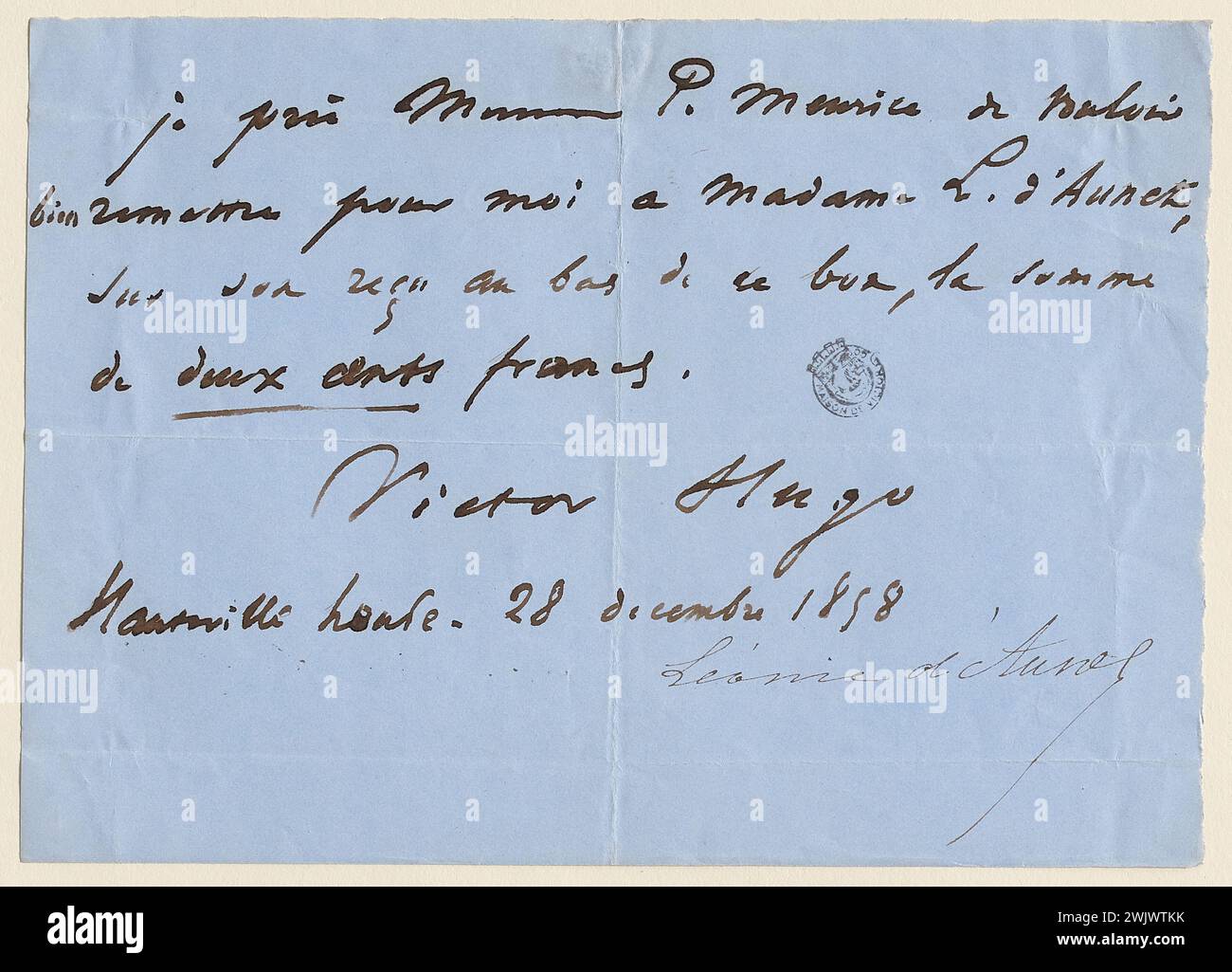 Hugo, Victor (N.1802-02-26-D.1885-05-22), Victor Hugo ticket to Paul Meurice for the payment of 200 F. to Léonie d'Aunet (dummy title), 1858-12-28. Ink on blue paper. Houses of Victor Hugo Paris - Guernsey. Stock Photo
