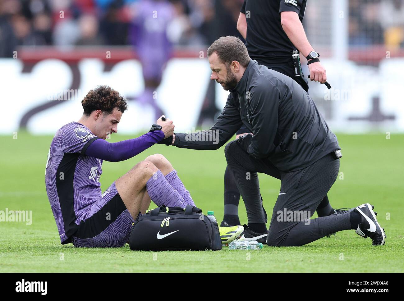 London, UK. 17th Feb, 2024. Curtis Jones of Liverpool is helped by