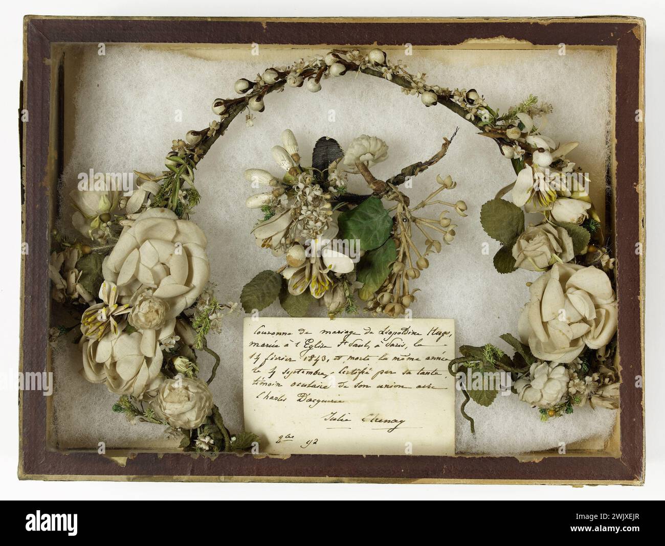 Anonymous. 'Léopoldine Hugo's bridal crown'. Fabric with imitation of white flowers and leaves on frame, in a cardboard and glass box. 1843. Paris, house of Victor Hugo. Hauteville House. 74552-1 White, crown, artificial flower, wedding, married, purete, union Stock Photo