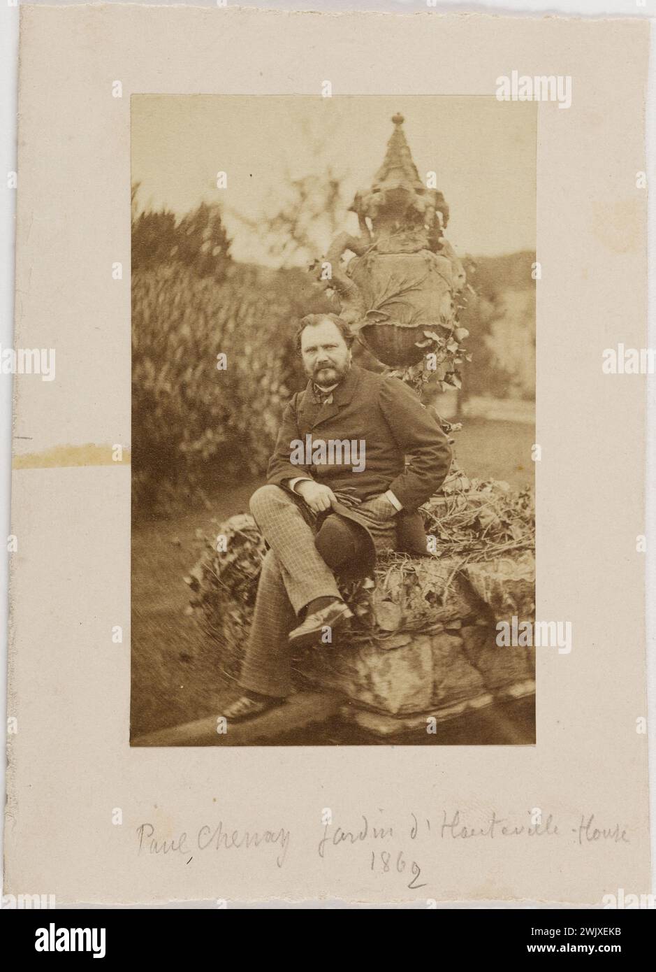 Paul Chenay seated on the edge of the snake fountain in the garden of Hauteville House '. Photography of Edmond Bacot (1814-1875). Draw on albumin paper. 1862. Paris, Maison de Victor Hugo. 101615-12 19th XIXth XIX 19th 19th 19th century Stock Photo