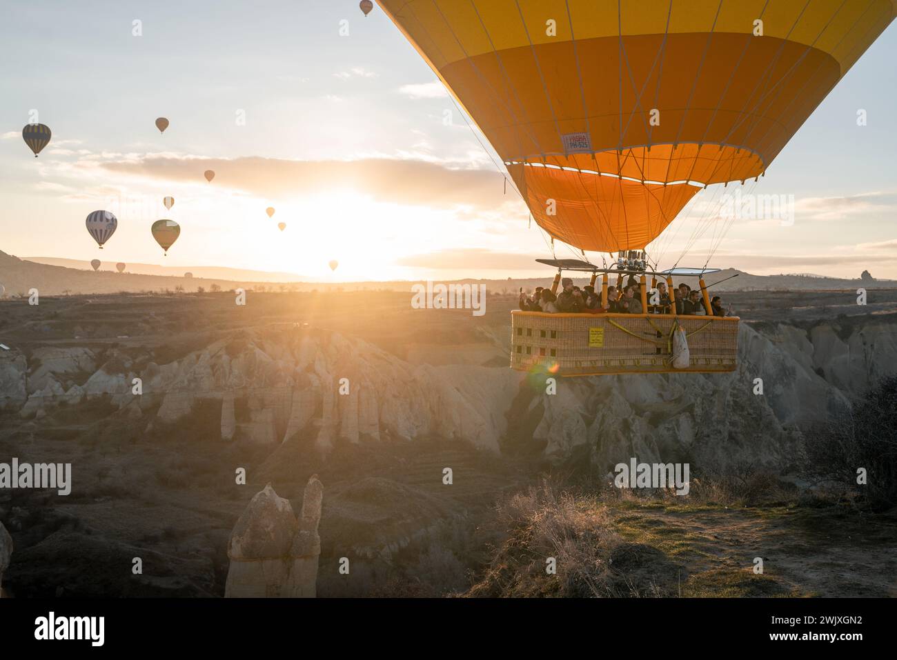 Göreme's Dawn: A Symphony of Balloons at Cappadocia's Sunrise Stock Photo