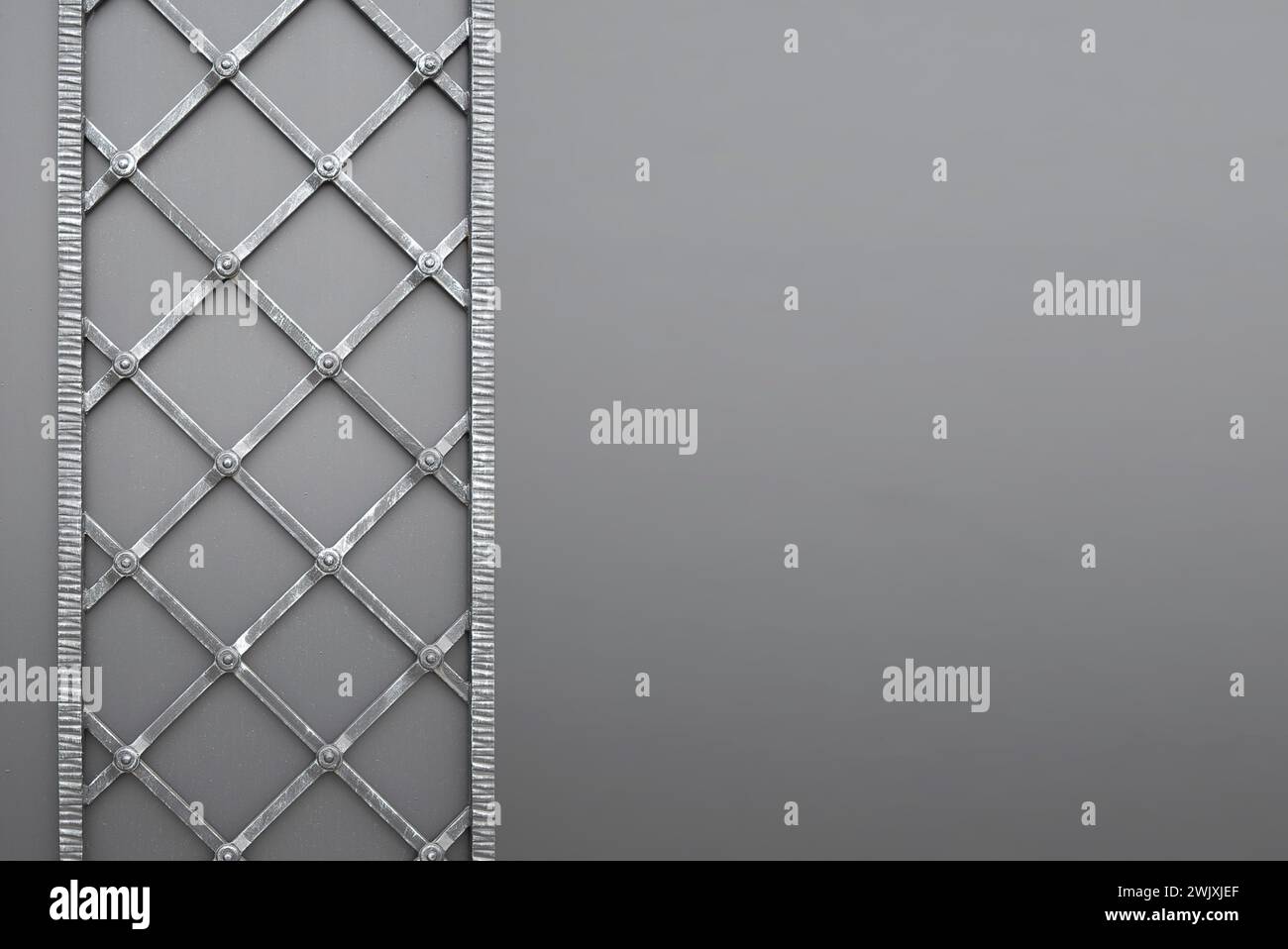 Forged decorative iron fence. A gray-blue patterned fence in an architectural and historical place. forged iron pattern metal texture on iron fence wa Stock Photo