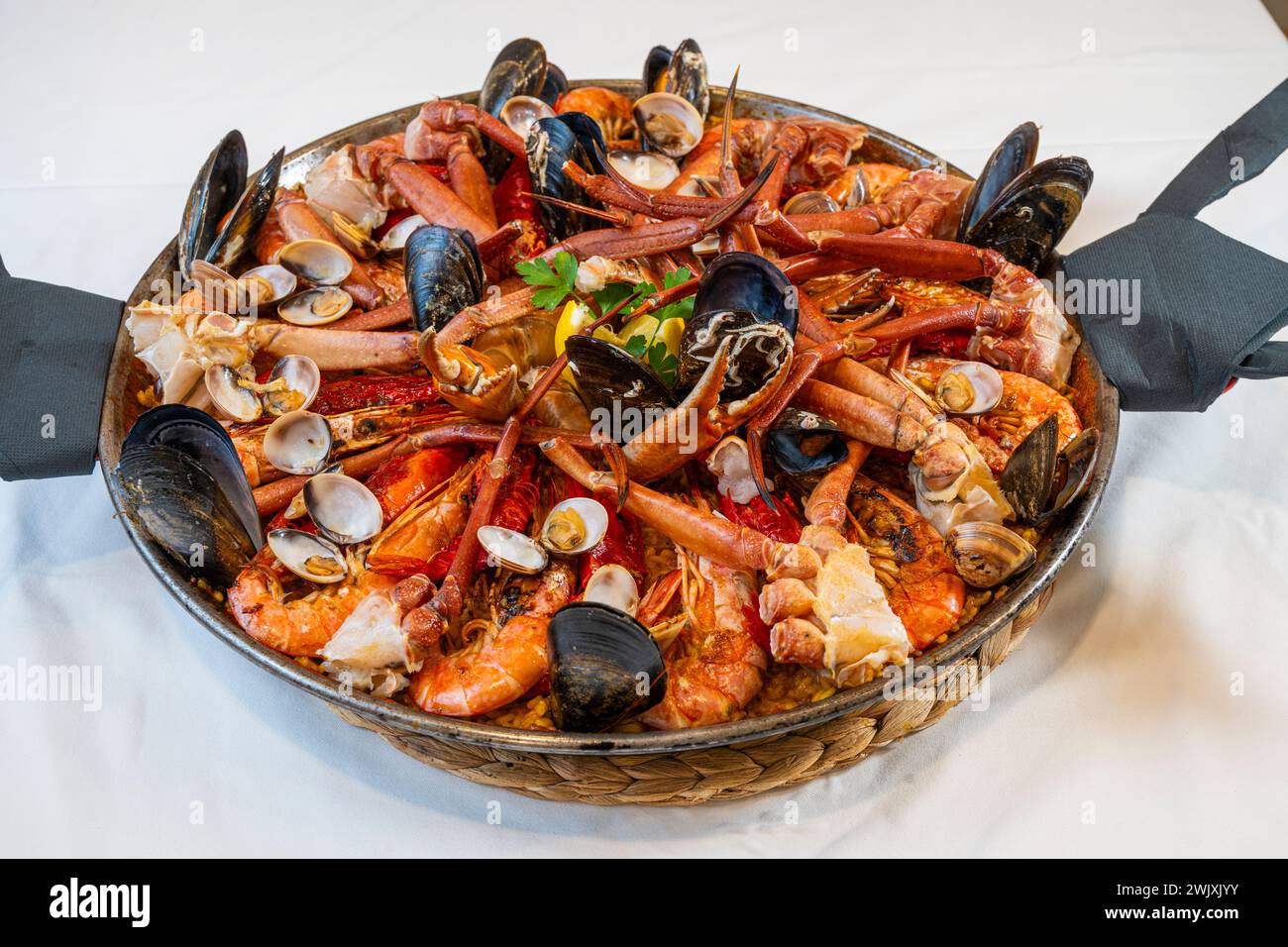 Closeup of traditional Spanish Paella de marisco with shrimps, prawns, mussels, crab, squid, clams Stock Photo