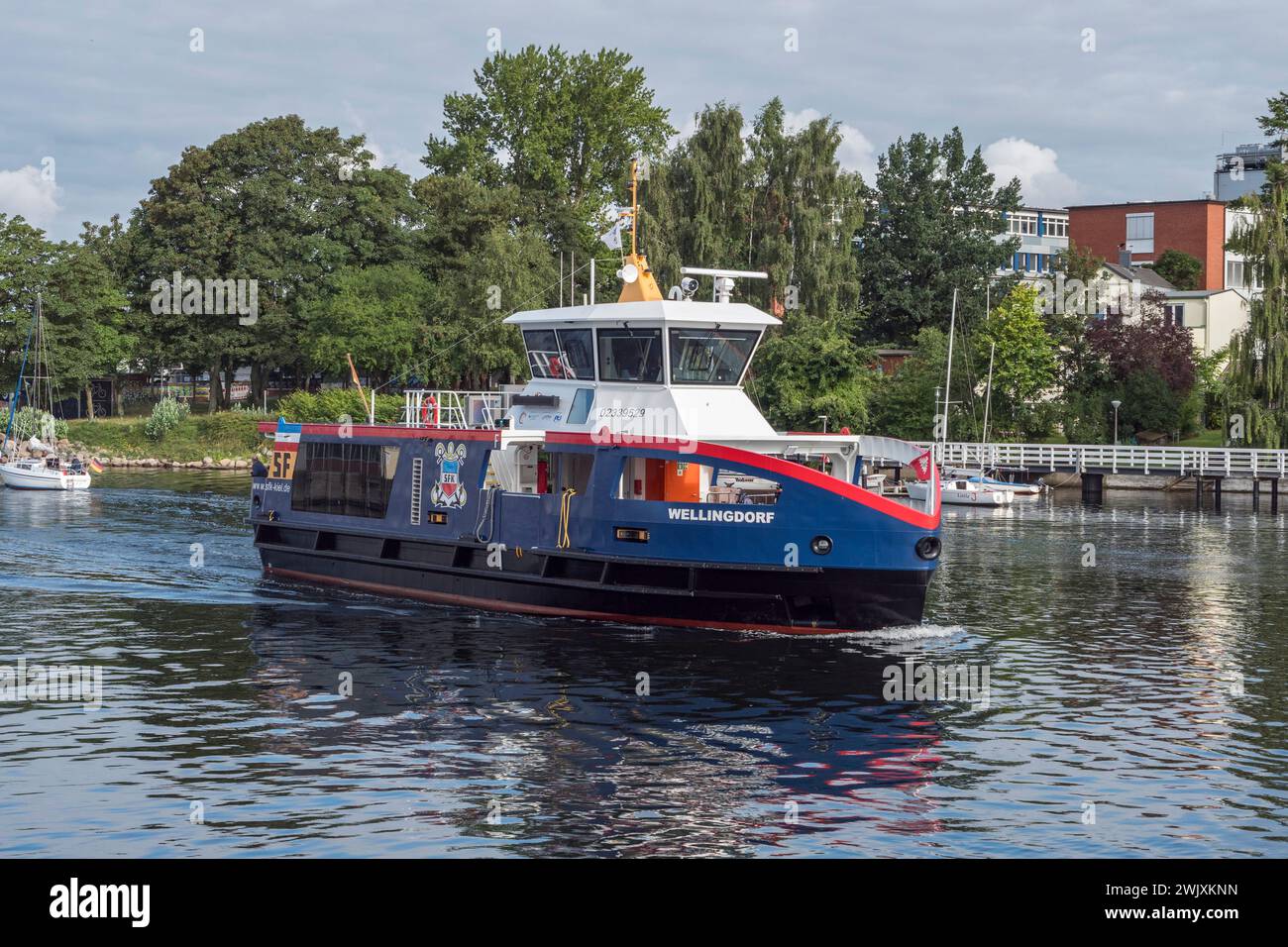 A local SFK ferry (Kiel Tug and Ferry Company) in the harbour in Kiel, Germany. Stock Photo