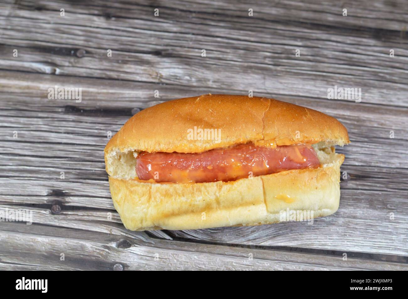 hot dog in a bun with thousand island dressing sauce of ketchup