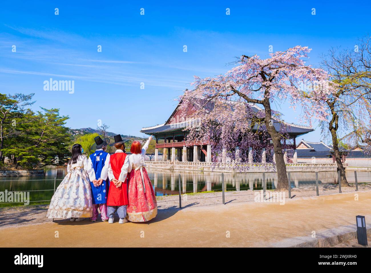 Korean couple with Korean traditional dress Hanbok in Gyeongbokgung palace in spring, seoul, south korea. Stock Photo