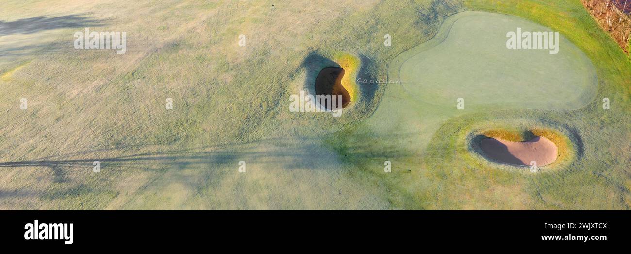 Golf course green aerial view and two players Stock Photo