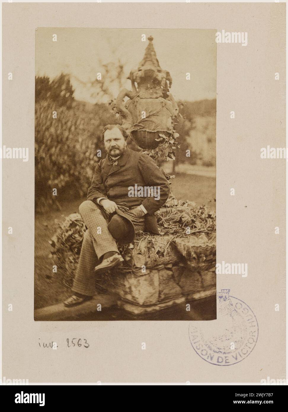 Paul Chenay seated on the edge of the snake fountain in the garden of Hauteville House '. Photography of Edmond Bacot (1814-1875). Draw on albumin paper. 1862. Paris, Maison de Victor Hugo. 101615-15 19th XIXth XIX 19th 19th 19th century Stock Photo