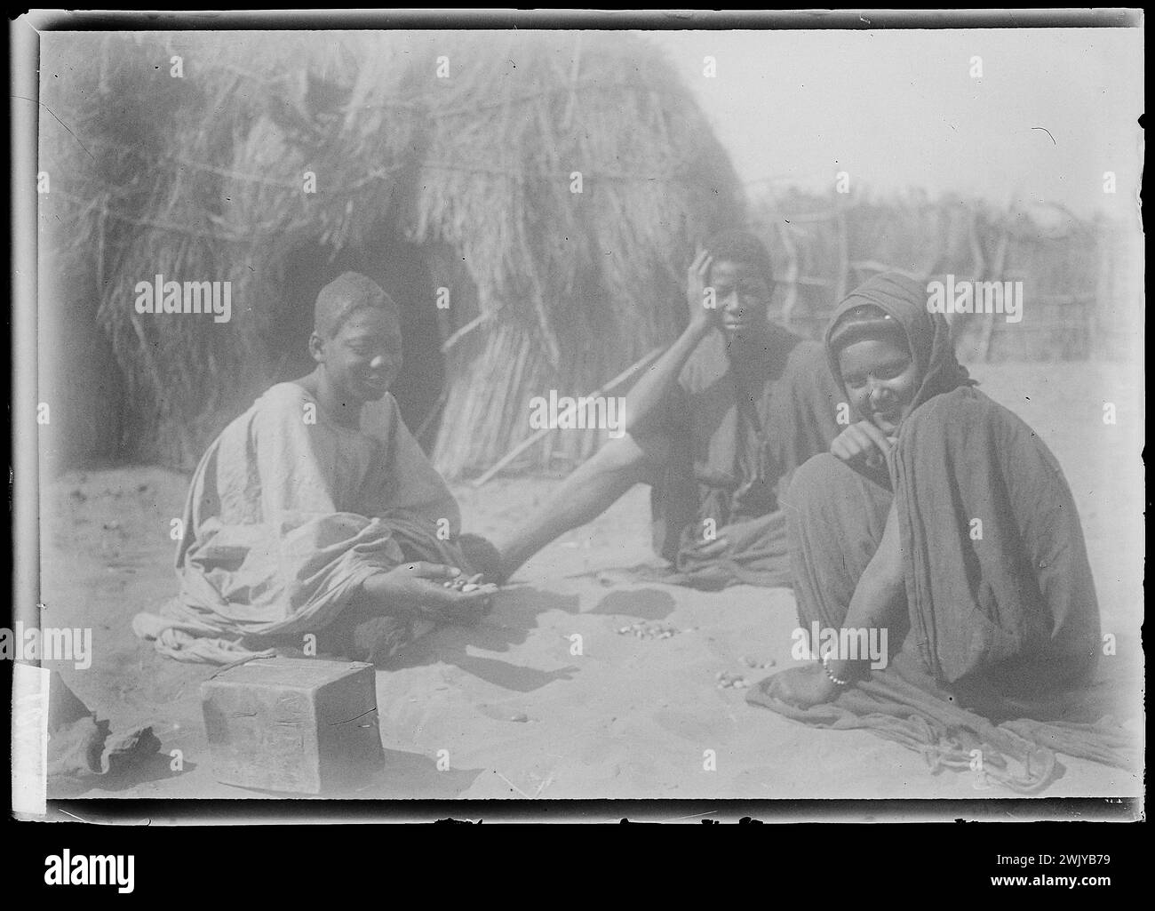 Installation of three men sitting in a camp (usual name). Glass photographic plate. Museum of Romantic Life. Stock Photo