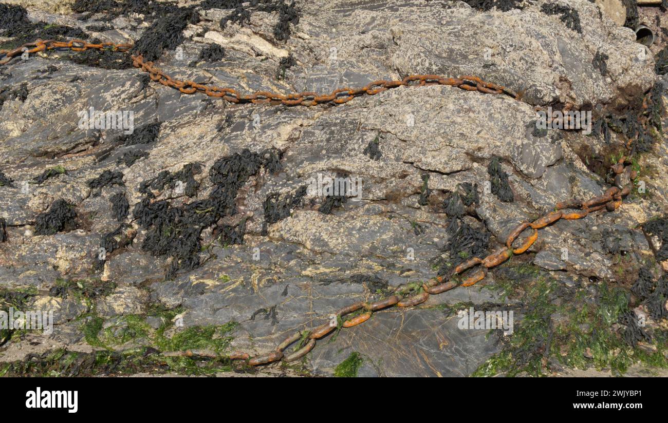 Old rusty chains on the seashore Stock Photo