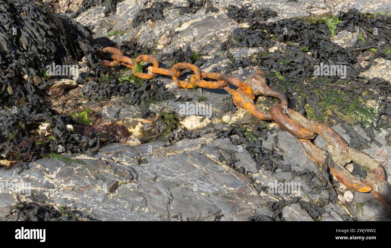 Old rusty chains on the seashore Stock Photo