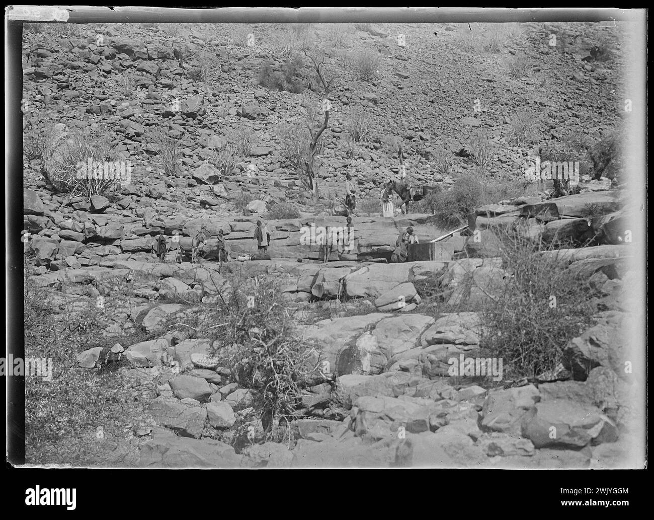 View of Africa - rocky landscape with characters and reserve of water (distant view (common name). Glass photographic plate. Museum of romantic life. Stock Photo