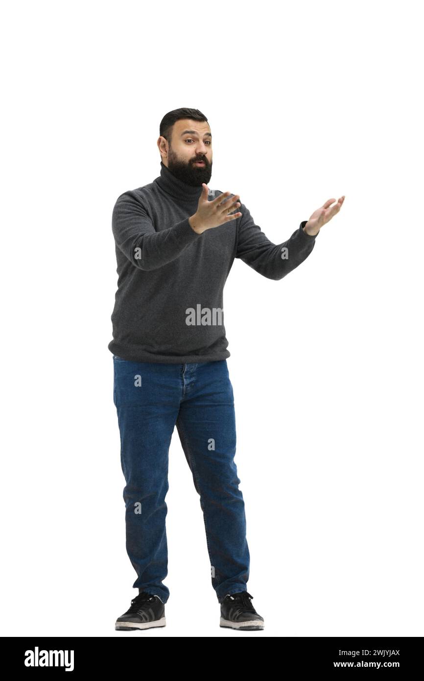 A man, full-length, on a white background, spreads his arms Stock Photo