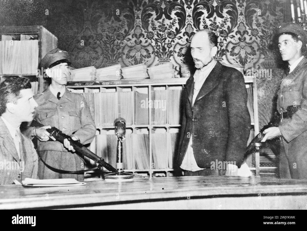 Maximilian Grabner Austrian Gestapo chief (standing) being questioned by Dr Heinrich Dumayer of the Viennese police in September 1945 Stock Photo