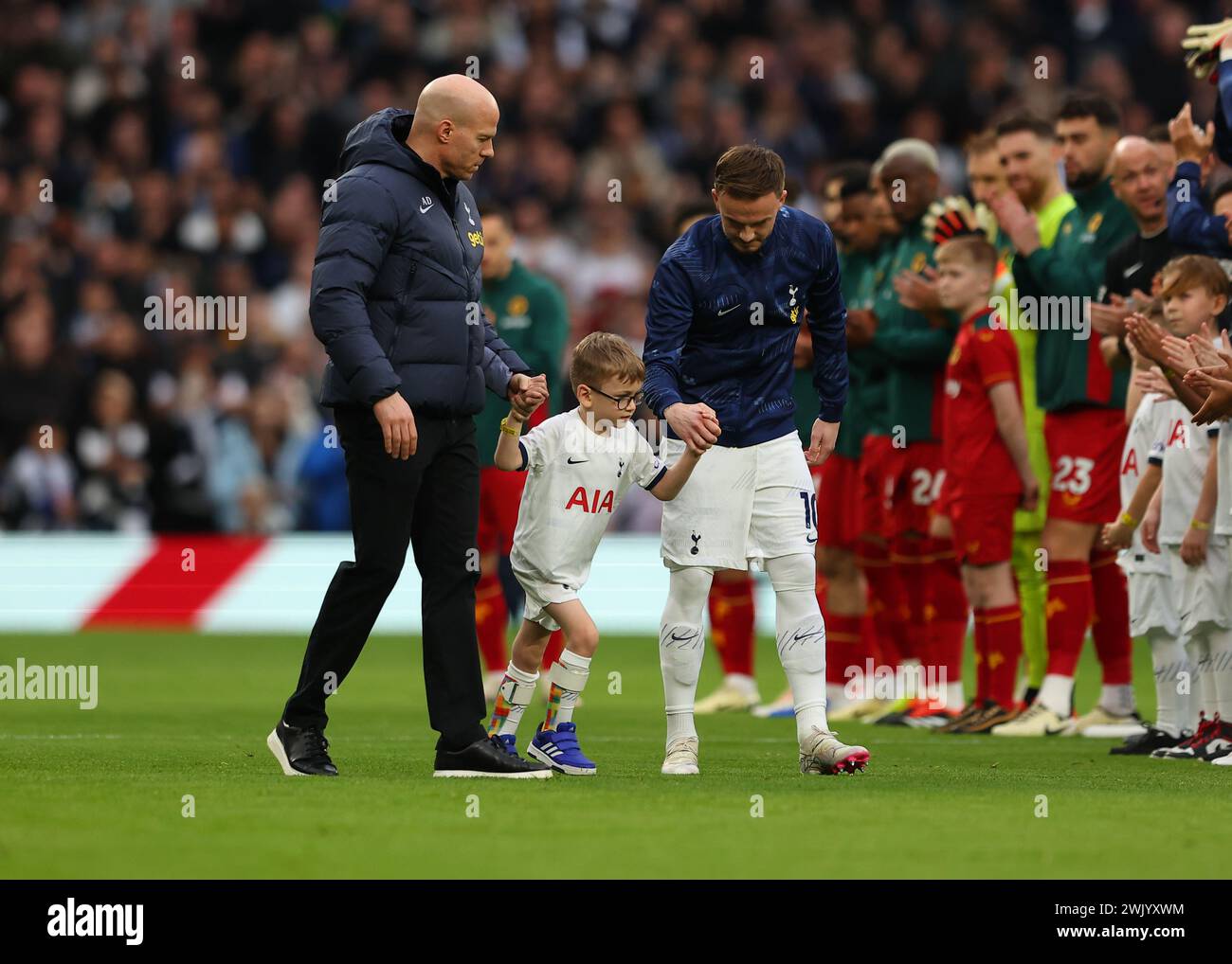 Tottenham Hotspur Stadium, London, UK. 17th Feb, 2024. Premier League Football, Tottenham Hotspur versus Wolverhampton Wanderers; Spurs mascot Samuel being lead onto the pitch by James Maddison of Tottenham Hotspur before kick off as Samuel is given a round of applause by the fans and teams Credit: Action Plus Sports/Alamy Live News Stock Photo