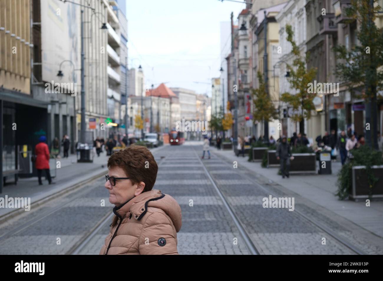 Woman walking in central Katowice, Poland Stock Photo