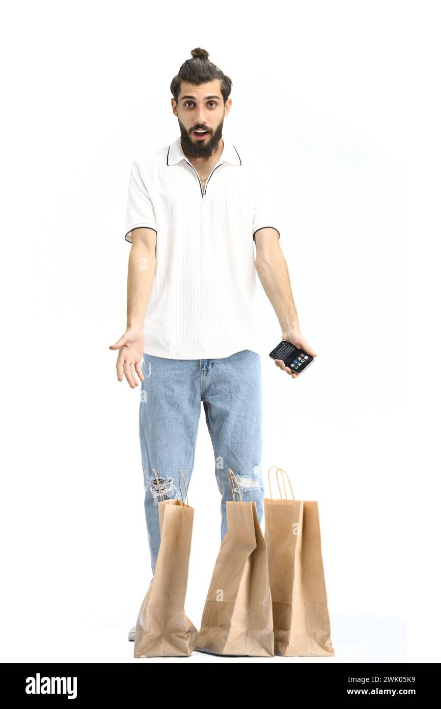 A man, full-length, on a white background, with bags and a phone Stock Photo