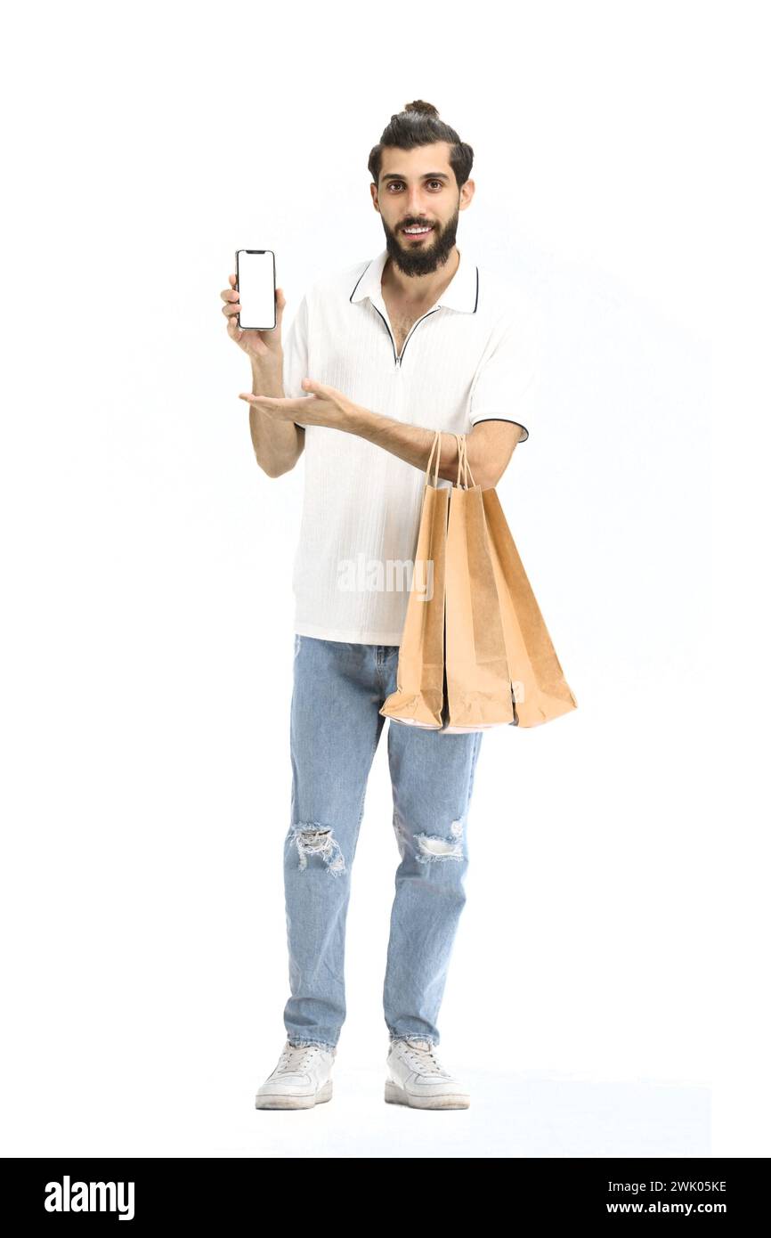 A man, full-length, on a white background, with bags and a phone Stock Photo