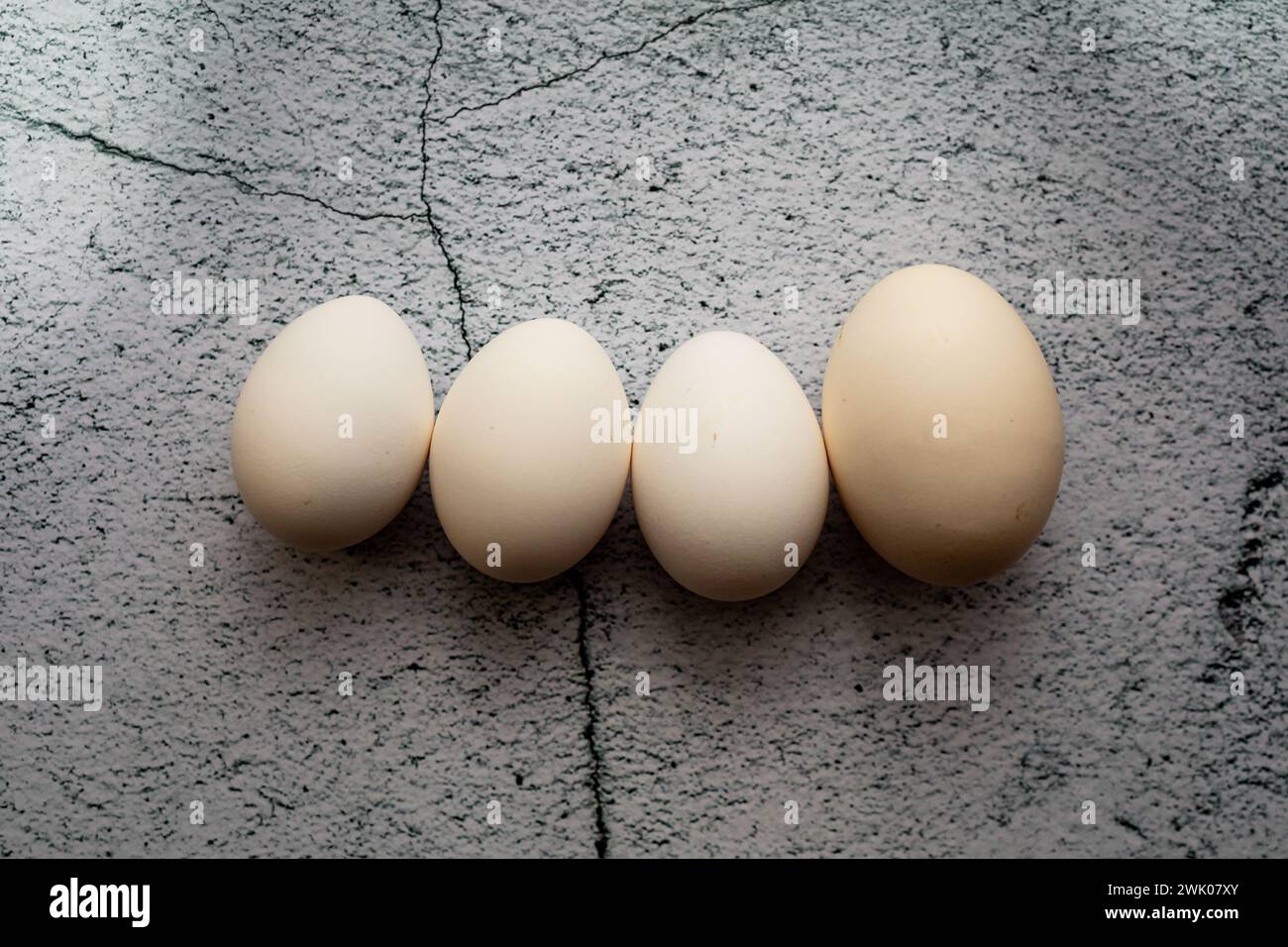 Four white eggs on an empty background. Easter concept Stock Photo