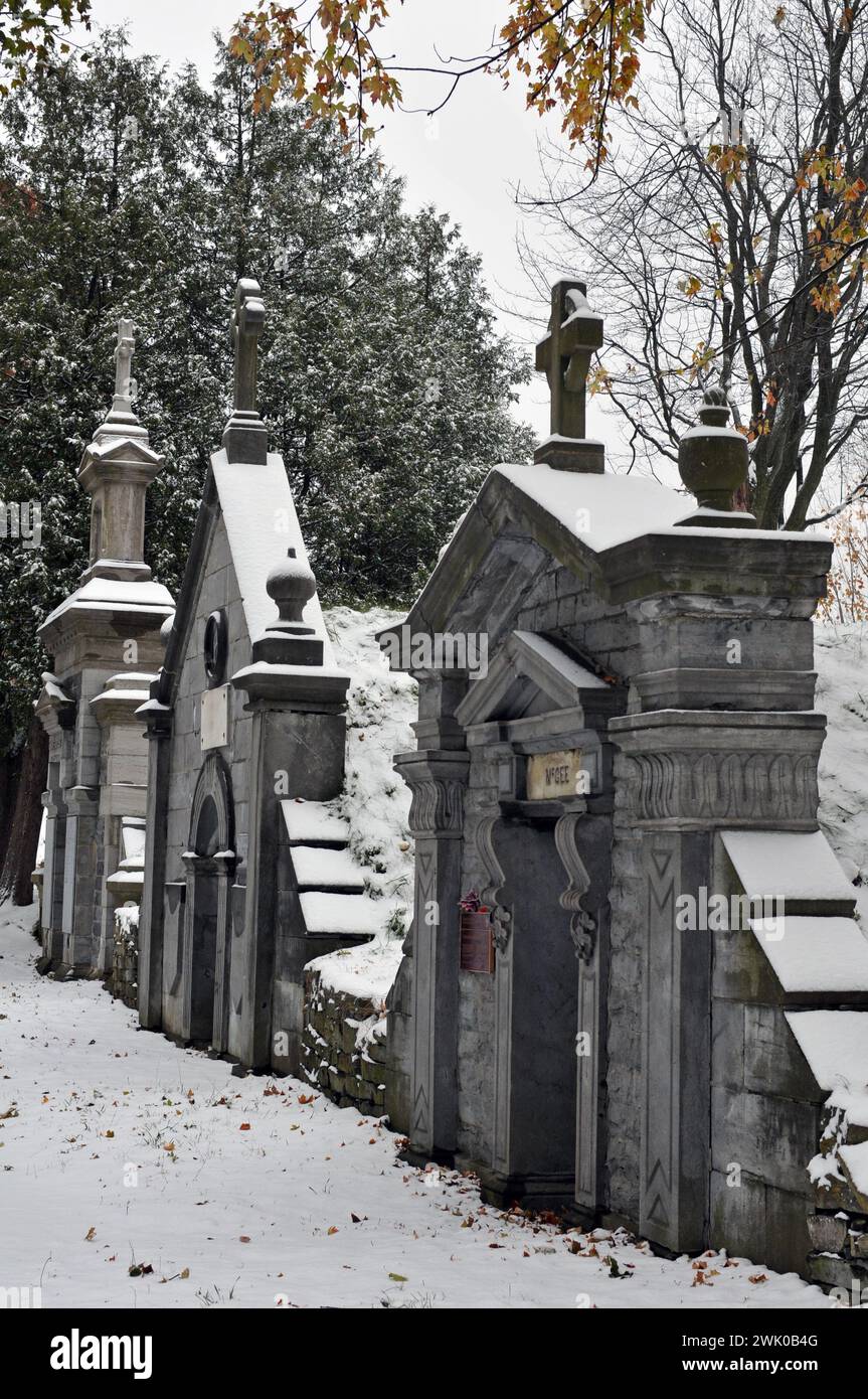 Snow covers historic mausoleums, including that of politician Thomas D'Arcy McGee, at Canada's largest cemetery, Notre-Dame-des-Neiges in Montreal. Stock Photo