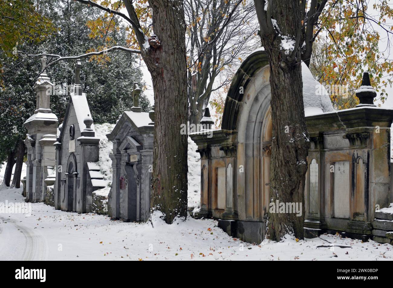 Snow covers a row of historic mausoleums at Montreal's Notre-Dame-des-Neiges Cemetery, the largest in Canada. Stock Photo