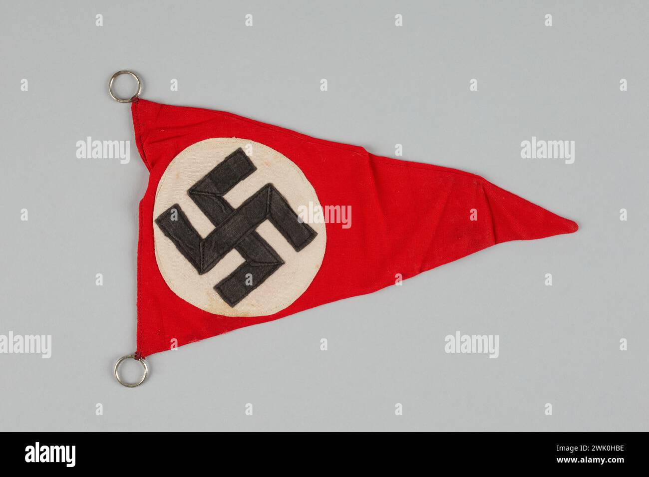 Anonymous, a small triangular flag with a swastika taken by a soldier from the 12th Cuirassiers regiment (attributed title), 1933. Fabric, metal, mechanical and manual seams. General Leclerc Museum of the Liberation of Paris - Jean Moulin Museum. Stock Photo