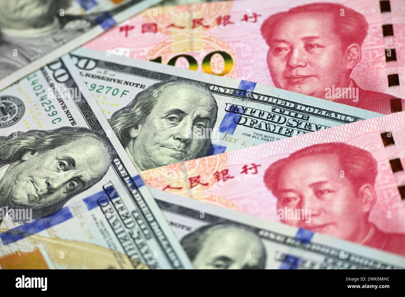 US dollars surrounded by Chinese yuan banknotes. Concept of trade war between the China and USA, economic, sanctions Stock Photo