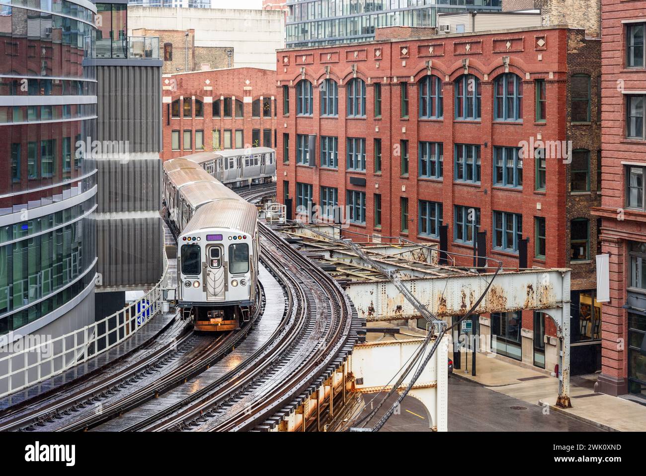 Chicago elevated commuter train on winding tracks in downtown on a rainy spring day Stock Photo