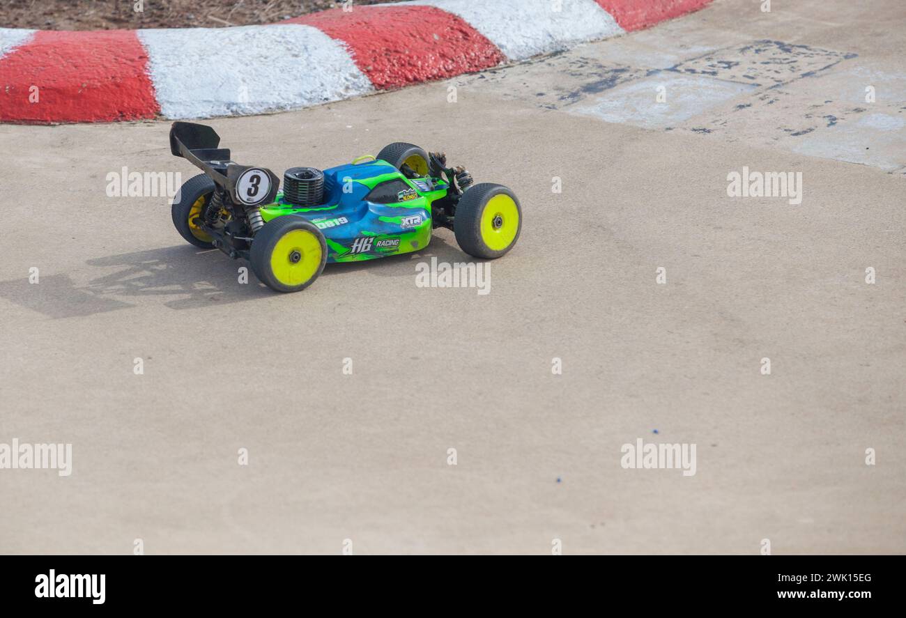 Merida, Spain - Jan 28th, 2024: Extremadura 1/8tt gas Championship RC Car. Cars making a curve over concrete surface Stock Photo