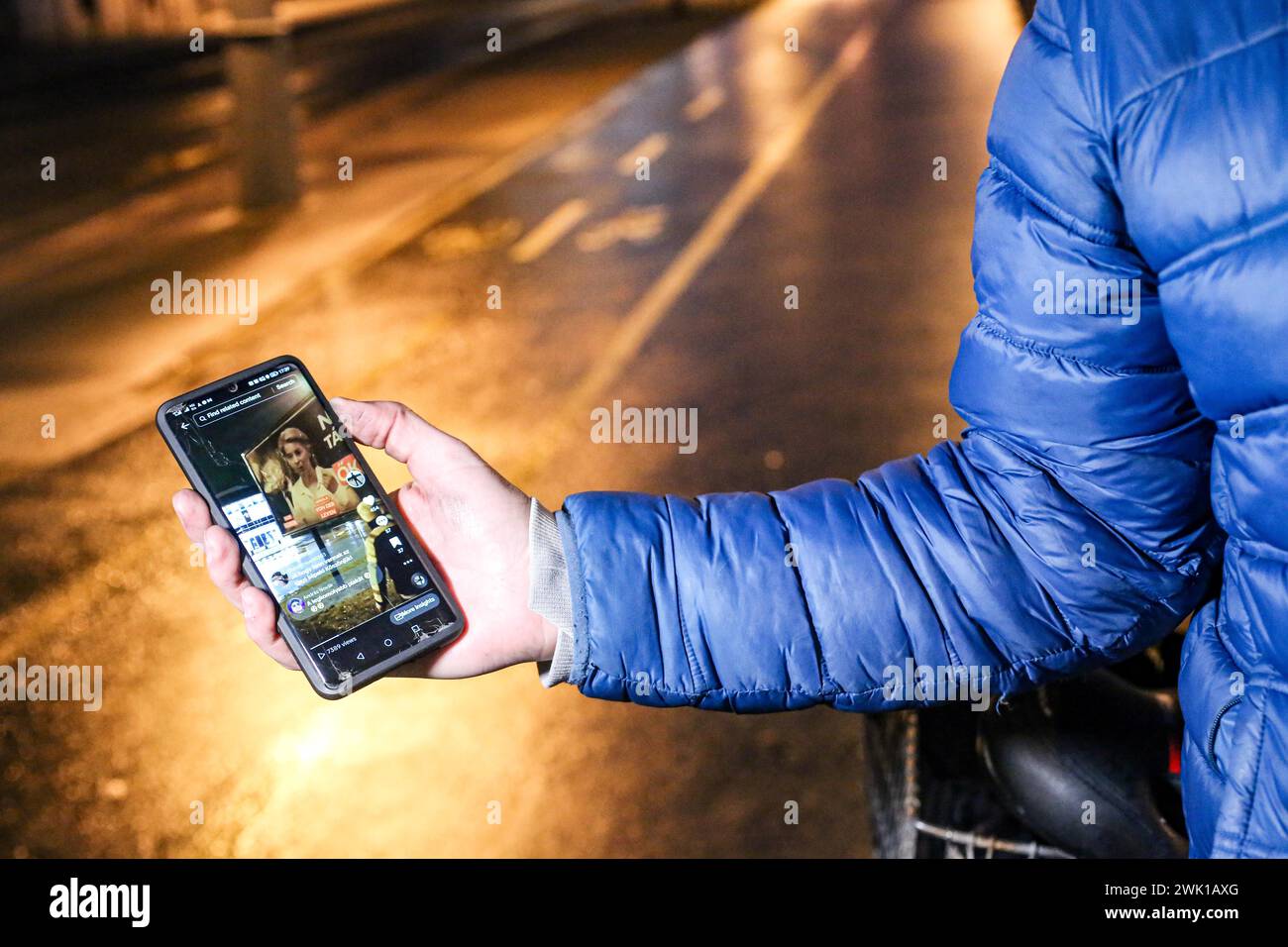 Budapest, Budapest, Hungary. 17th Feb, 2024. Hungarian activist, Balasz T., holds a phone demonstrating efforts by other activists and influencers the day after a massive protest took place in the capital towards Hungarian Prime Minister VIKTOR ORBAN and on the three resignations of Hungarian President, KATALIN NOVAK; former Minister and leadership of Hungarian Reform Church, ZOLTAN BALOG and former Justice Minister, JUDIT VARGA following exposure of a man pardoned last year from covering up pedophilia in a children's home. The reveal has caused embarrassment and tarnished the image of Hu Stock Photo