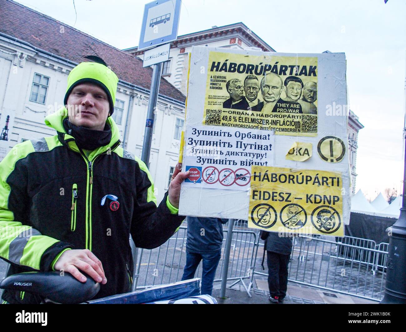 Budapest, Budapest, Hungary. 17th Feb, 2024. A Hungarian activist with his bike, holds sign saying War Party in front of Varkert, where Hungarian Prime Minister VIKTOR ORBAN made his annual speech and comments on three resignations of Hungarian President, KATALIN NOVAK; former Minister and leadership of Hungarian Reform Church, ZOLTAN BALOG and former Justice Minister, JUDIT VARGA following exposure of a man pardoned last year from covering up pedophilia in a children's home. The reveal has caused embarrassment and tarnished the image of Hungary's safe zone and high family value image. Stock Photo