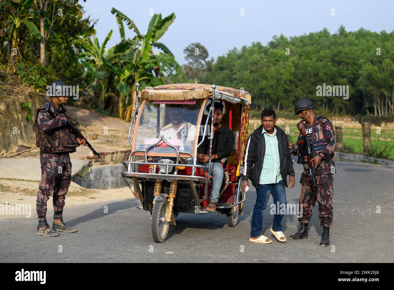 Bandarban, Bangladesh. 13th Feb, 2024. Members of the BGB are checking civilians in the Naikhongchori area near the Bangladesh-Myanmar border in the Bandarban district of Bangladesh. The BGP's conflict with the Arakan Army, an armed rebel group inside Myanmar, continues unabated. Sustained firing, the sound of mortar shells bursting could be heard across the Bangladesh-Myanmar border area. Bullets and mortar shells fired from Myanmar are coming across the border in the towns of Bangladesh. Credit: SOPA Images Limited/Alamy Live News Stock Photo