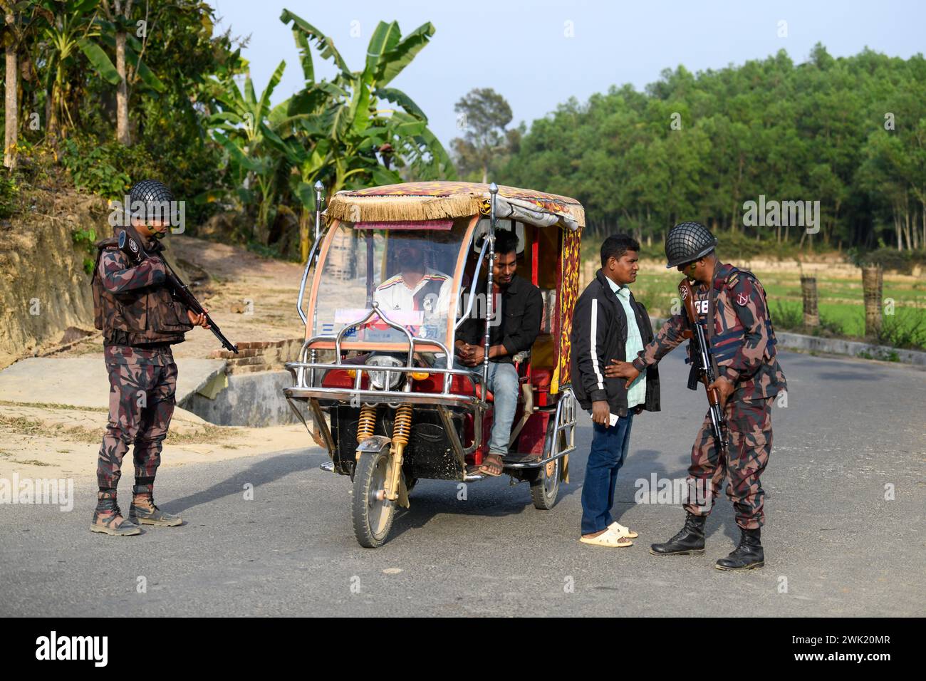 Bandarban, Bangladesh. 13th Feb, 2024. Members of the BGB are checking civilians in the Naikhongchori area near the Bangladesh-Myanmar border in the Bandarban district of Bangladesh. The BGP's conflict with the Arakan Army, an armed rebel group inside Myanmar, continues unabated. Sustained firing, the sound of mortar shells bursting could be heard across the Bangladesh-Myanmar border area. Bullets and mortar shells fired from Myanmar are coming across the border in the towns of Bangladesh. (Photo by Piyas Biswas/SOPA Images/Sipa USA) Credit: Sipa USA/Alamy Live News Stock Photo