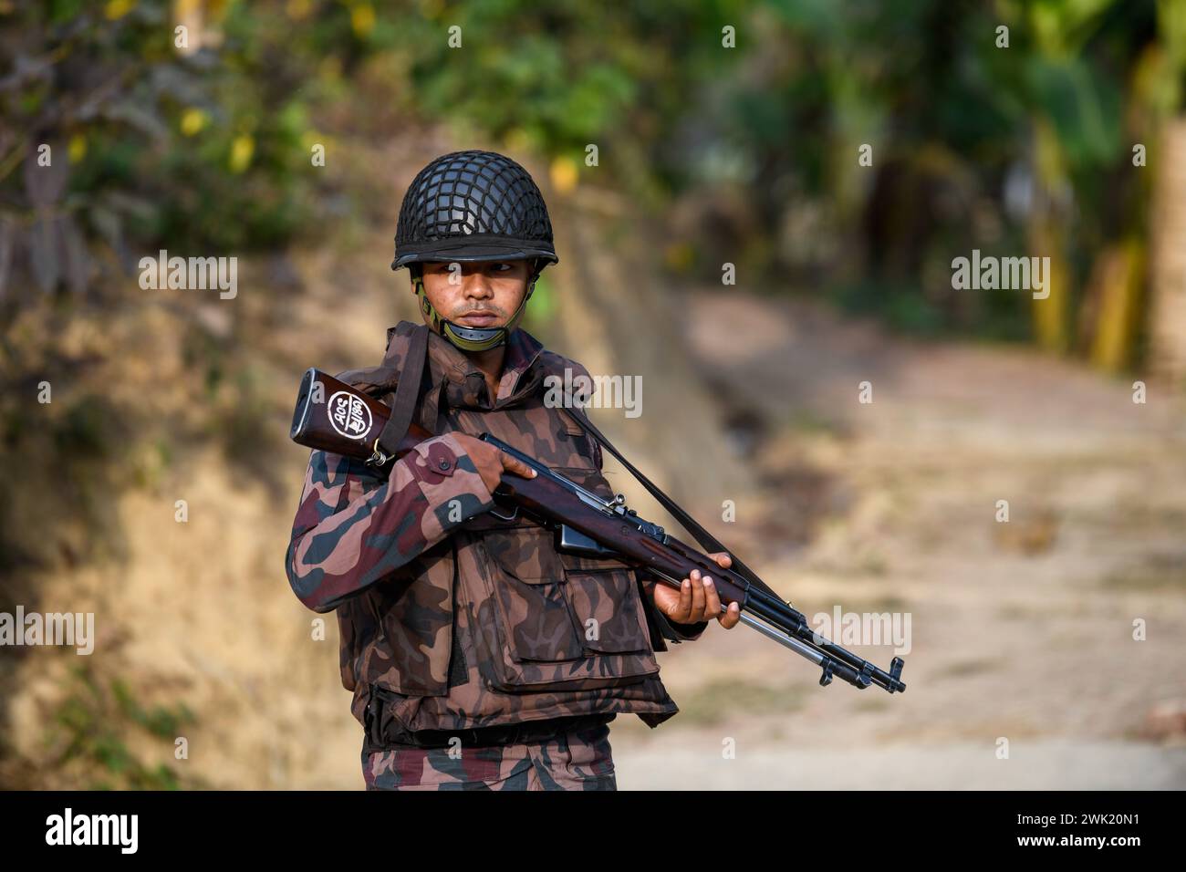 Bandarban, Bangladesh. 13th Feb, 2024. A member of the BGB stands on guard in the Naikhongchori area near the Bangladesh-Myanmar border in the Bandarban district of Bangladesh. The BGP's conflict with the Arakan Army, an armed rebel group inside Myanmar, continues unabated. Sustained firing, the sound of mortar shells bursting could be heard across the Bangladesh-Myanmar border area. Bullets and mortar shells fired from Myanmar are coming across the border in the towns of Bangladesh. (Photo by Piyas Biswas/SOPA Images/Sipa USA) Credit: Sipa USA/Alamy Live News Stock Photo