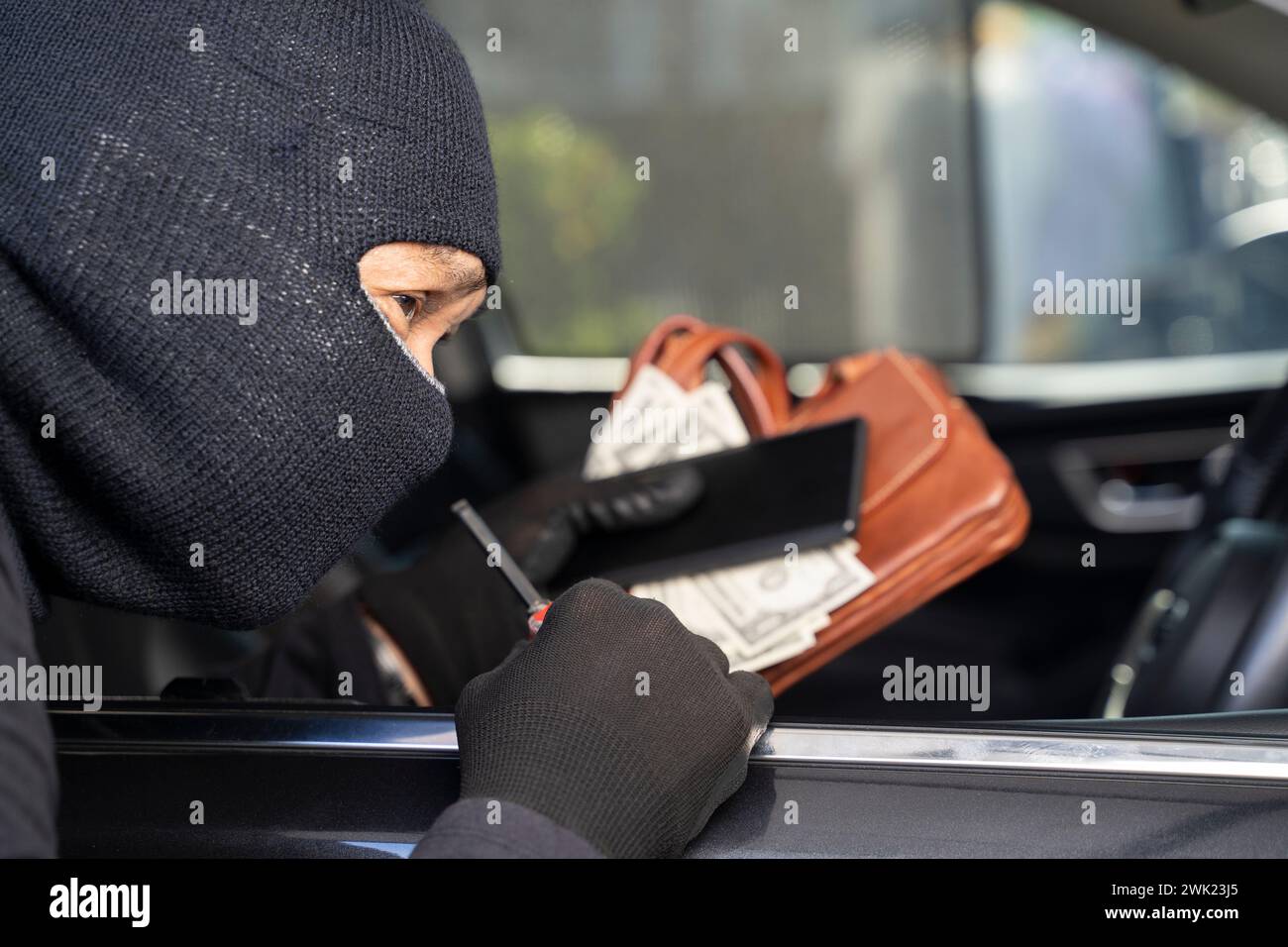 Thieves steal wallet and phone from car seat. Stock Photo