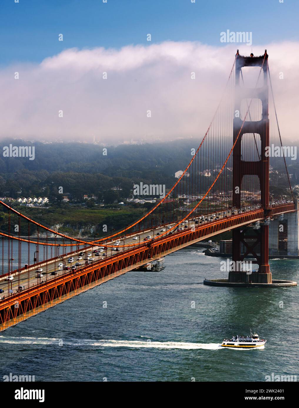 A ship sailing beneath the iconic Golden Gate Bridge in San Francisco, California. Stock Photo