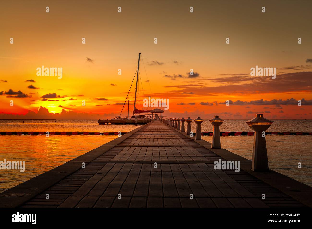 The pier towards the horizon at sunset on Grand Cayman Stock Photo