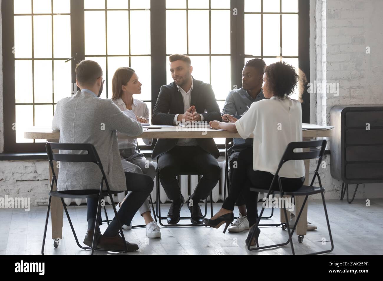 Young office workers having a meeting with director Stock Photo